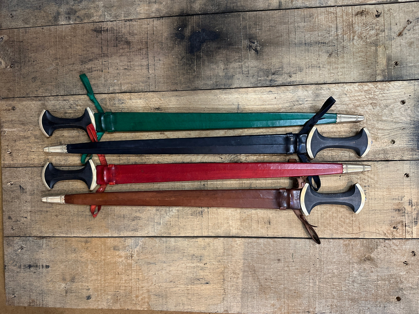 Long Swiss Degen from Tod Cutler. Four swords in scabbards demonstrating the colours red, green, black and brown. 