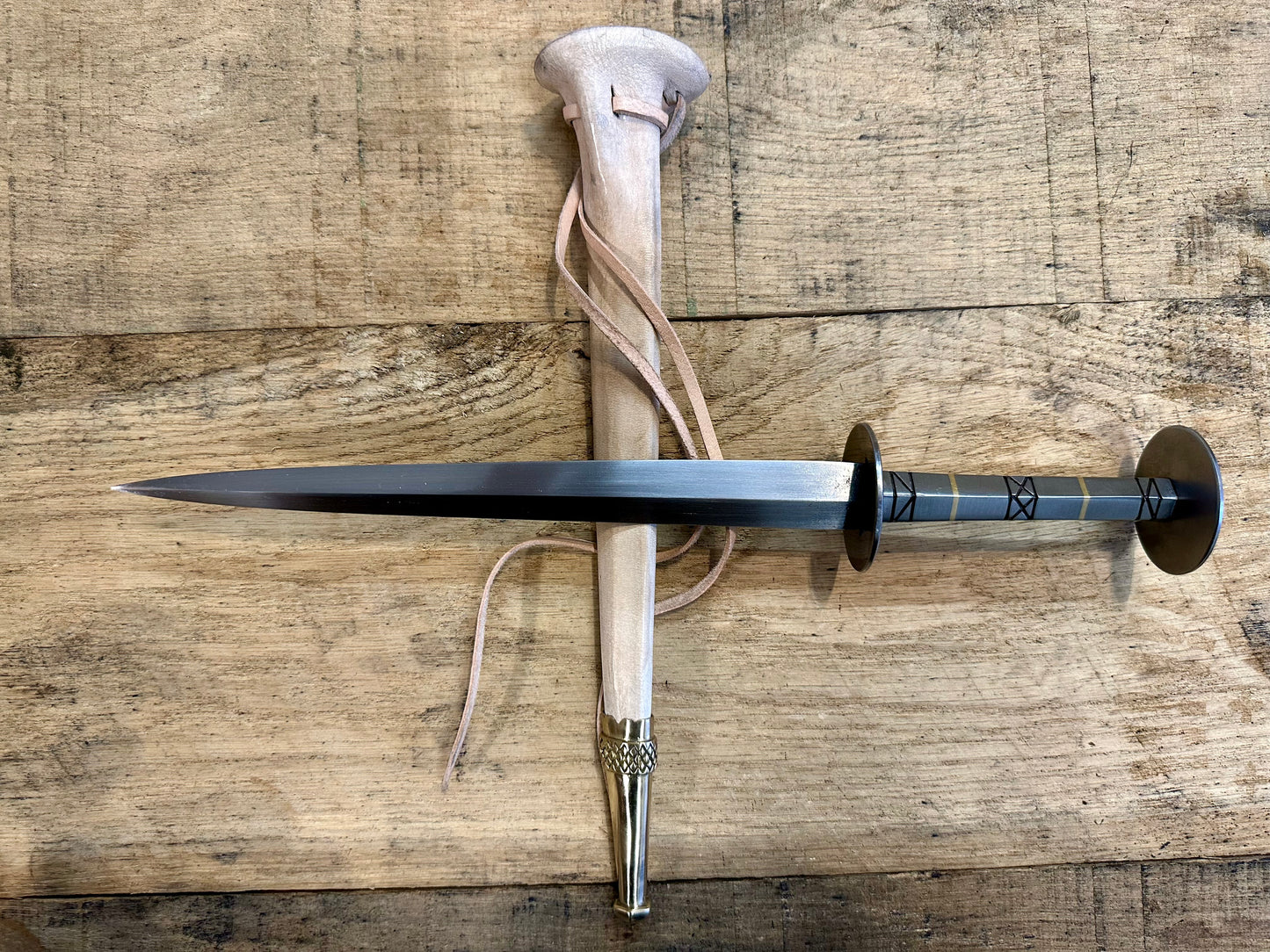 
                  
                    German Steel Rondel with a natural sheath
                  
                