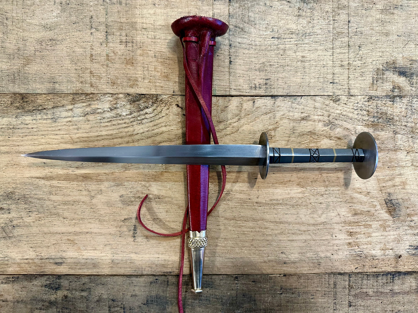 
                  
                    German Steel Rondel with a red sheath
                  
                