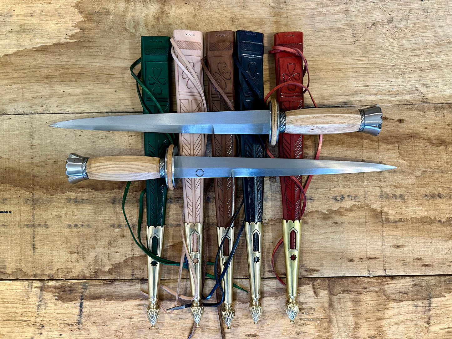 Tod Cutler English Rondel. Two daggers pictured on a range of coloured sheathes.