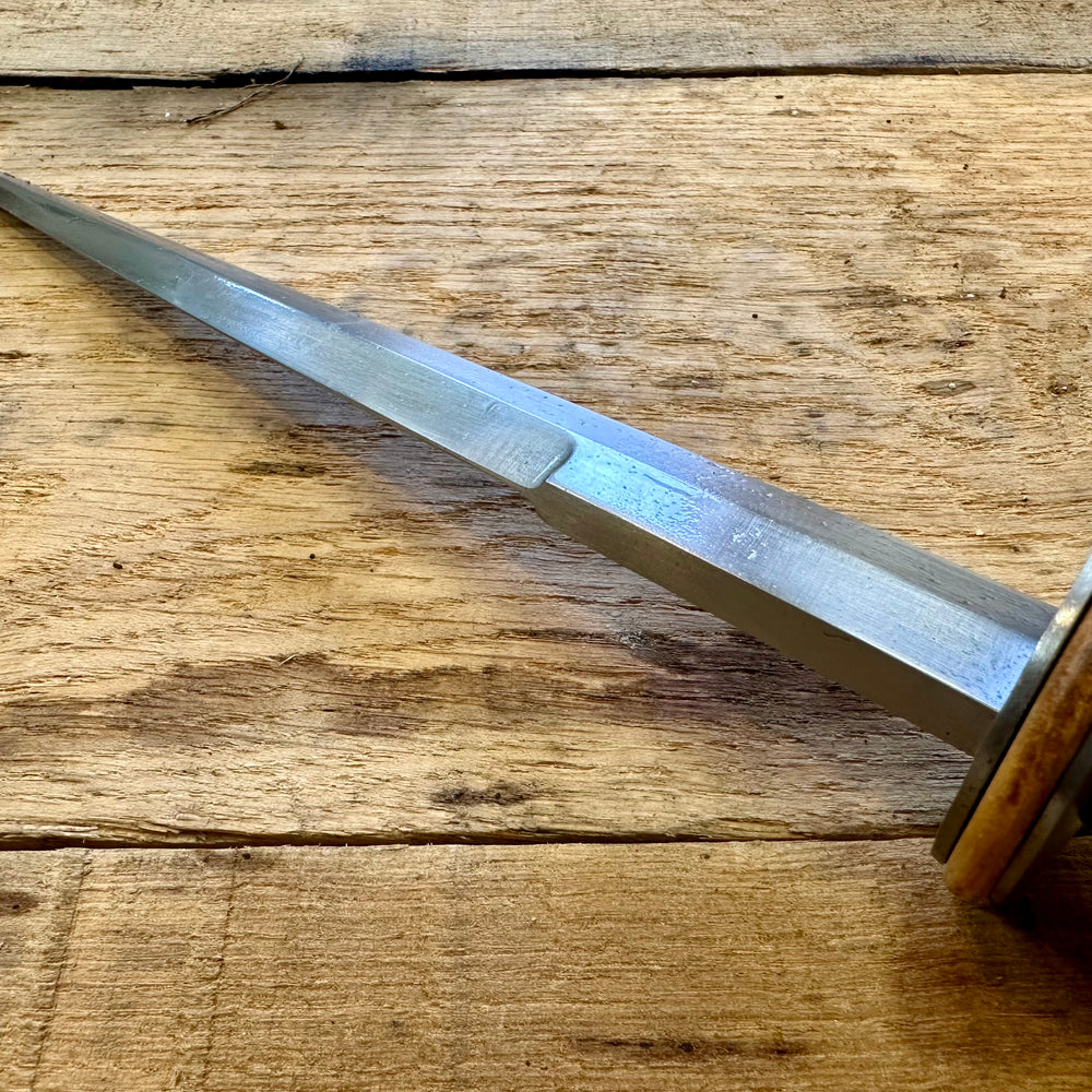 
                  
                    Tod Cutler English Rondel.  Highlighting the false edge on the blade.
                  
                