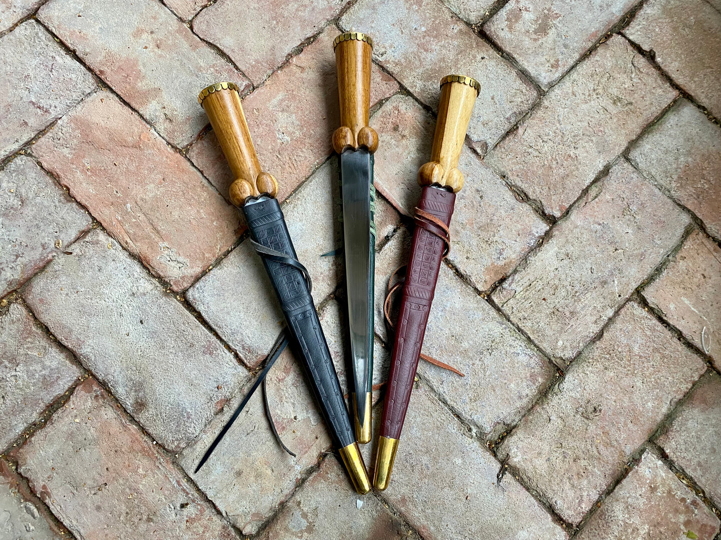 Tod Cutler TC30 bollock dagger on a brick background
