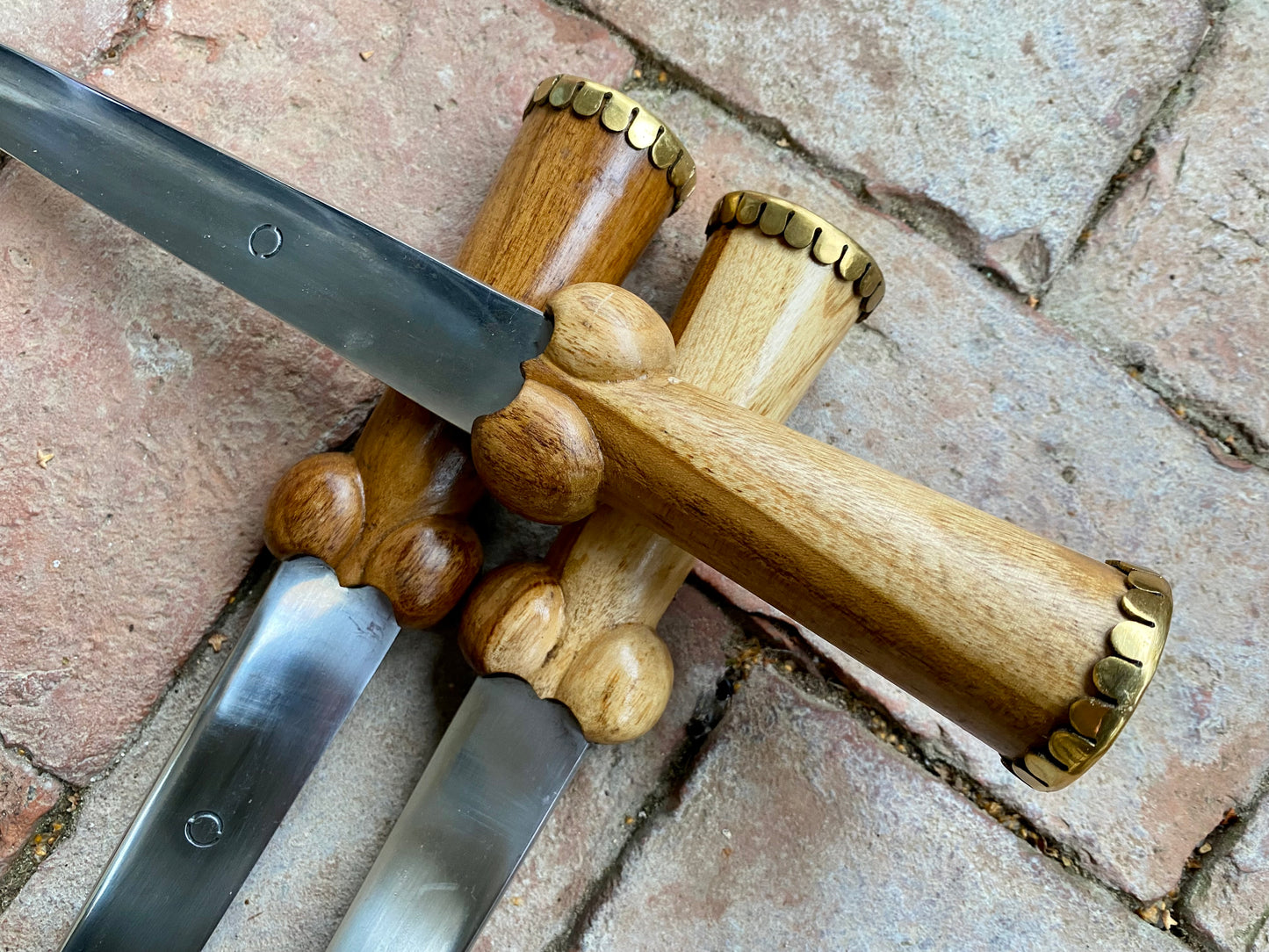 Tod Cutler TC30 bollock dagger on a brick background