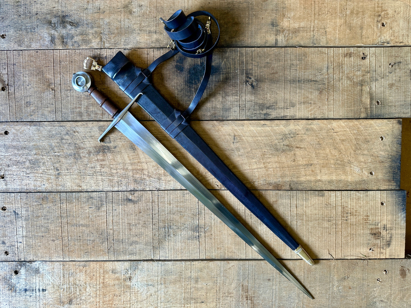 
                  
                    Castillon single handed sword with a black scabbard
                  
                