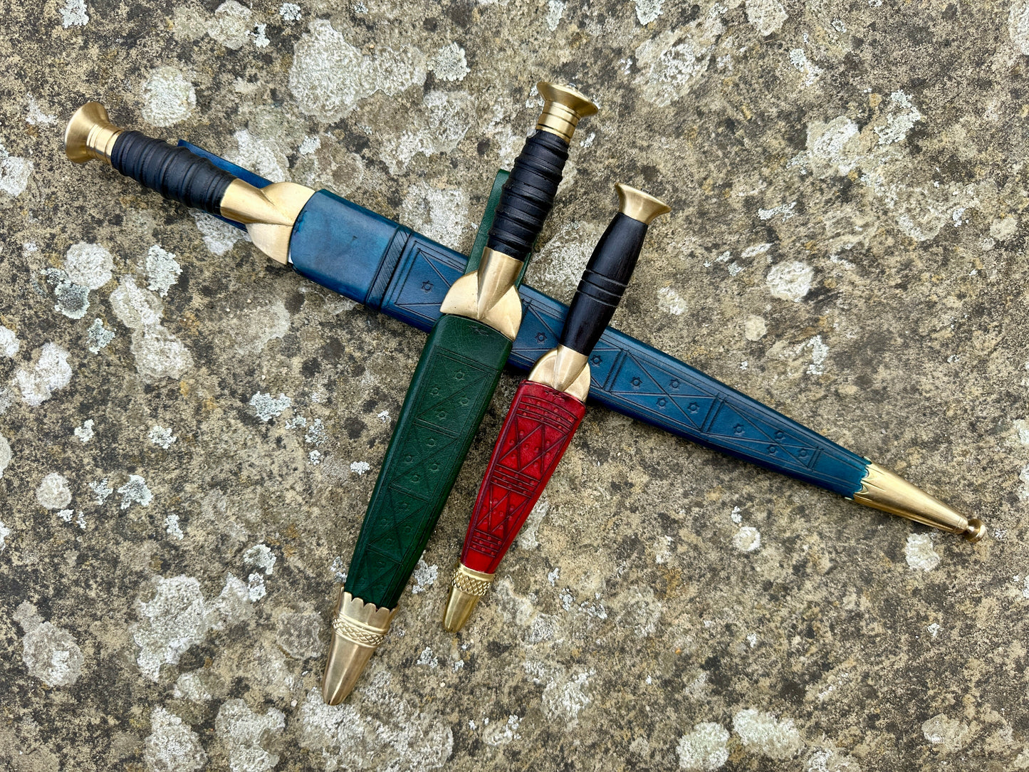 The Highland Bundle. Three dirks in scabbards. Blue, green and red.