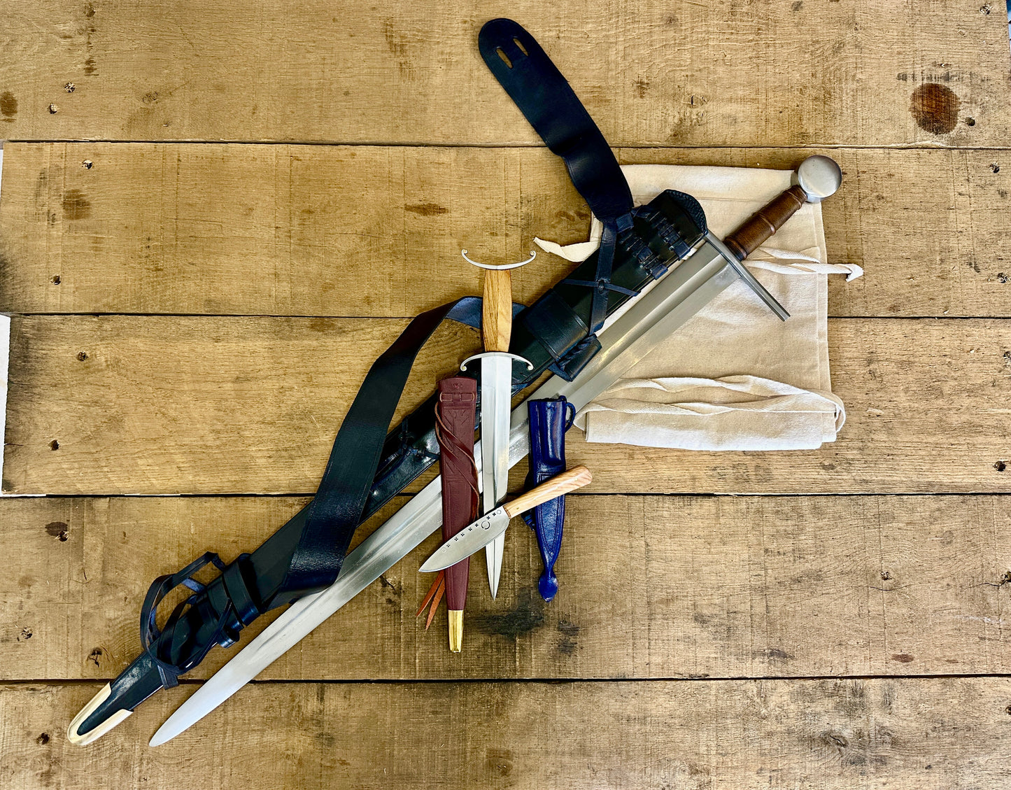 
                  
                    12th Century single-handed sword, 11-14th Century Antennae Dagger and 12-14th Century Peasants eating knife with sword bag (out of scabbards)
                  
                