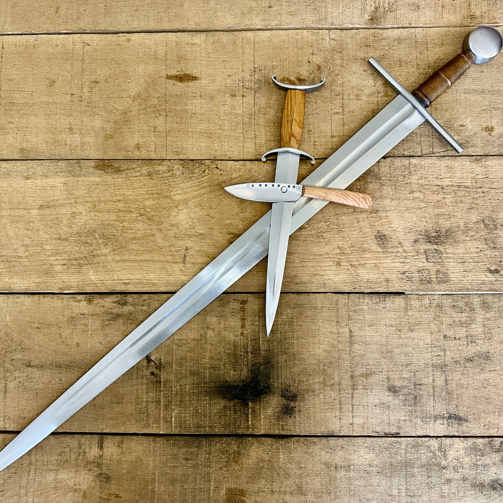 
                  
                    12th Century single-handed sword, 11-14th Century Antennae Dagger and 12-14th Century Peasants eating knife crossed (no scabbards)
                  
                