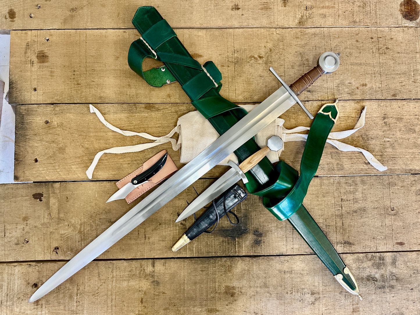 
                  
                    13 - 15th Century Single-handed sword, Late 13th Century Quillon Dagger, 13 - 15th Century Horn folding knife and sword bag (out of scabbards)
                  
                