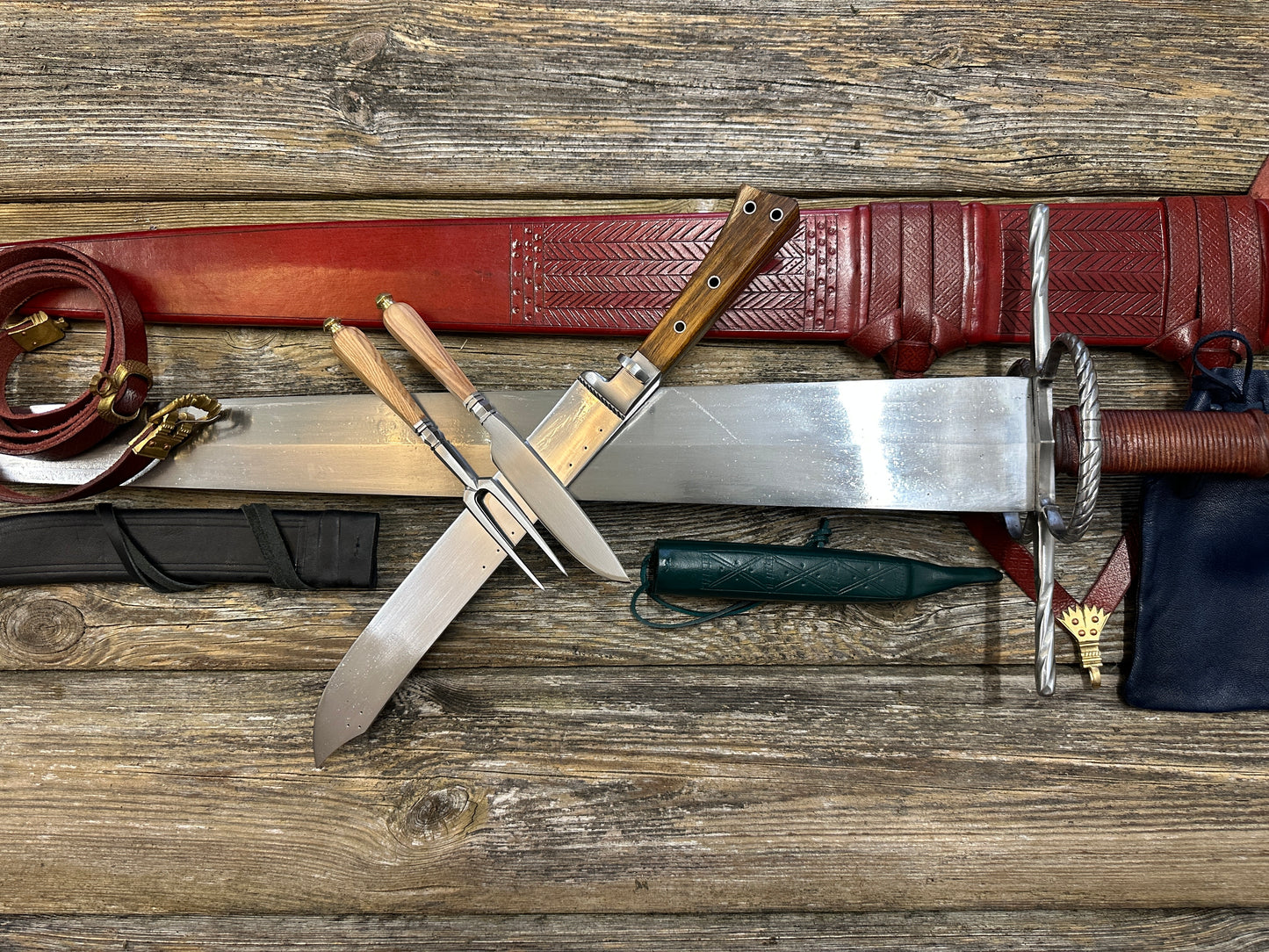 
                  
                    The Big Weapon Bundle. Sword, knife, eating set with sheathes and leather pouch. 
                  
                