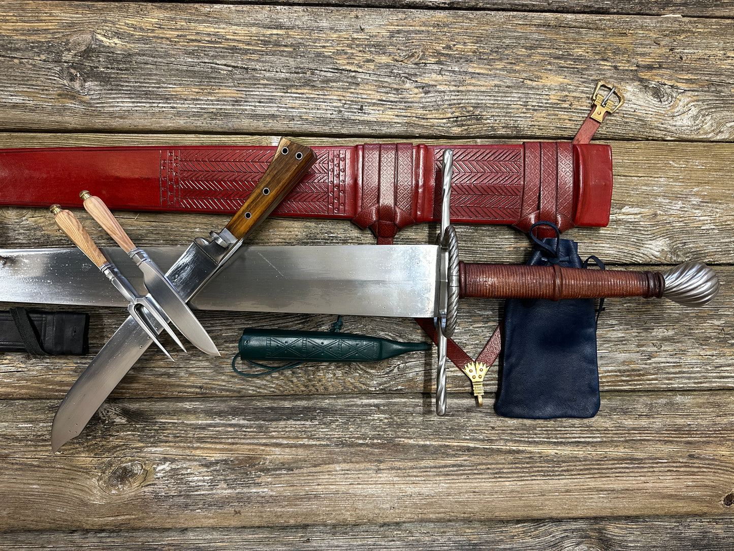 
                  
                    The Big Weapon Bundle. Sword, knife, eating set with sheathes and leather pouch. 
                  
                