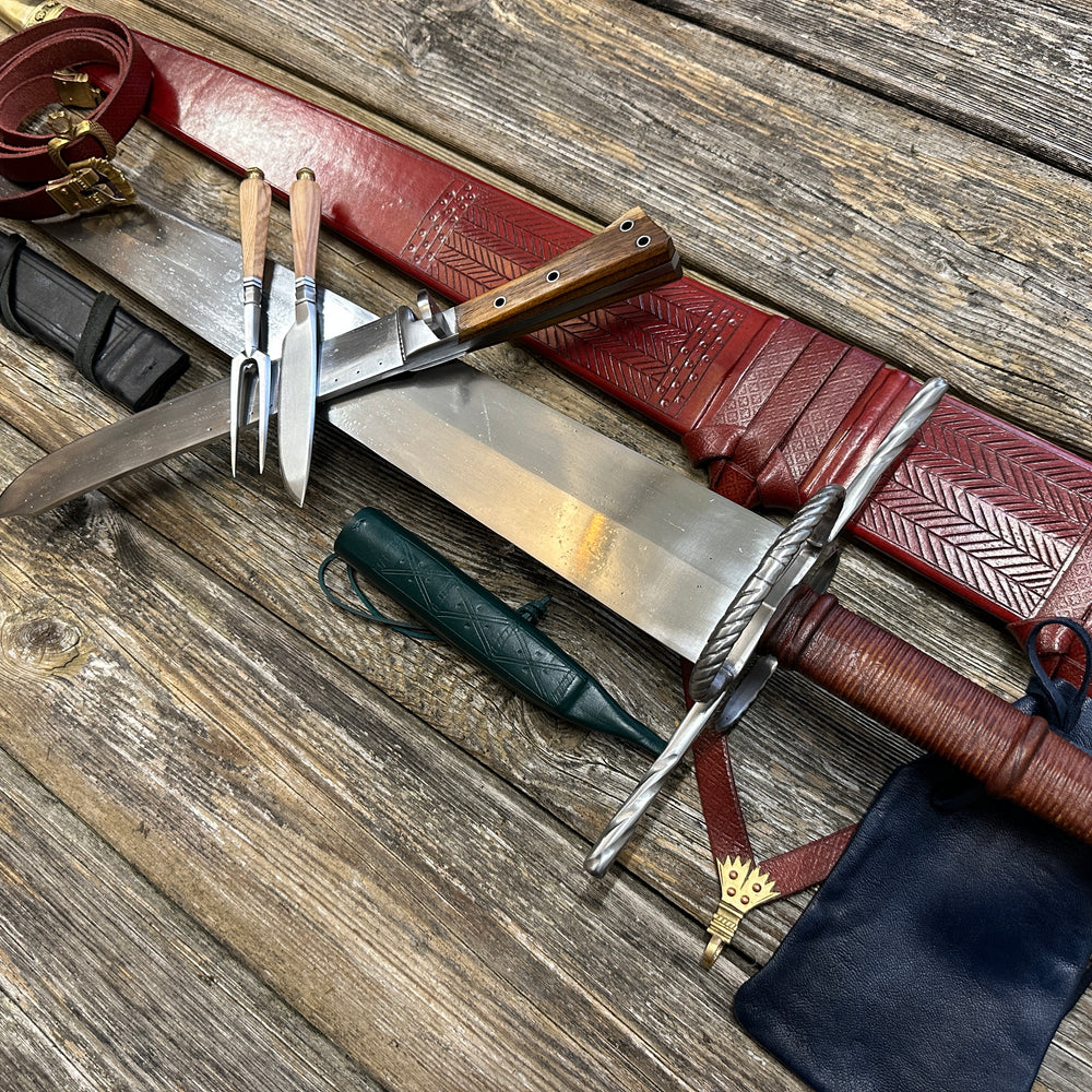 
                  
                    The Big Weapon Bundle. Sword, knife, eating set with sheathes and leather pouch. 
                  
                