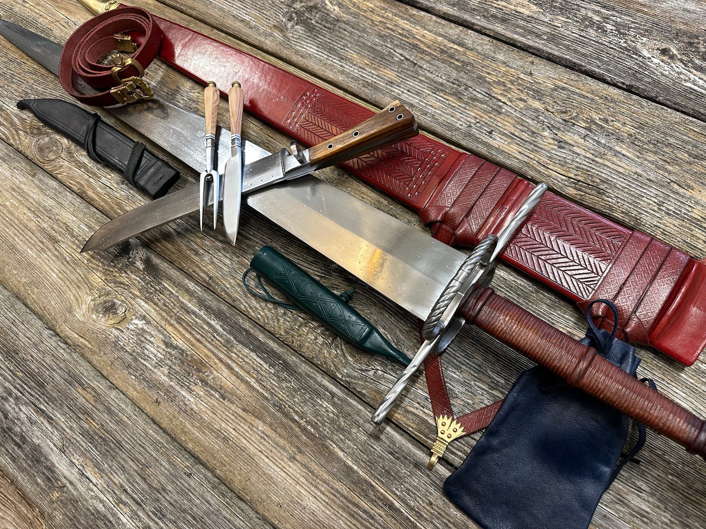 
                  
                    The Big Weapon Bundle. Sword, knife, eating set with sheathes and leather pouch. 
                  
                
