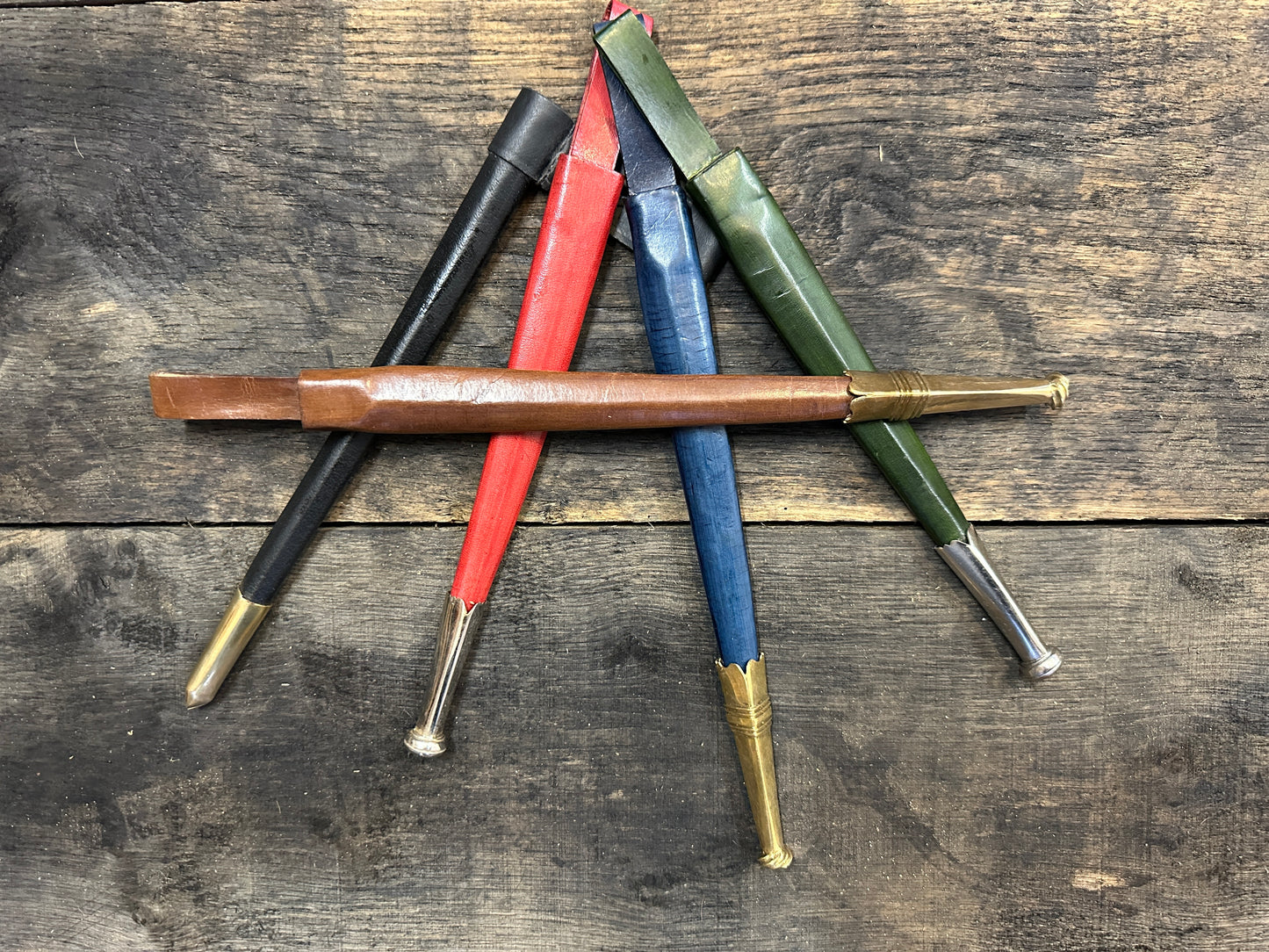 
                  
                    black, red, blue and green sheathes with a brown sheath lying across the top. 
                  
                