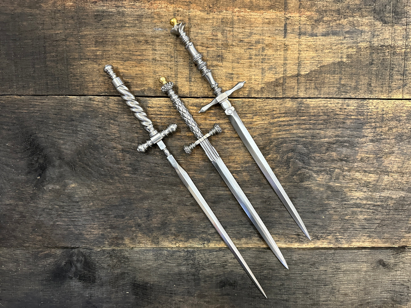 
                  
                    The Stibbert, the Pitt Rivers and the original Tod Cutler Stiletto daggers on a piece of wood
                  
                