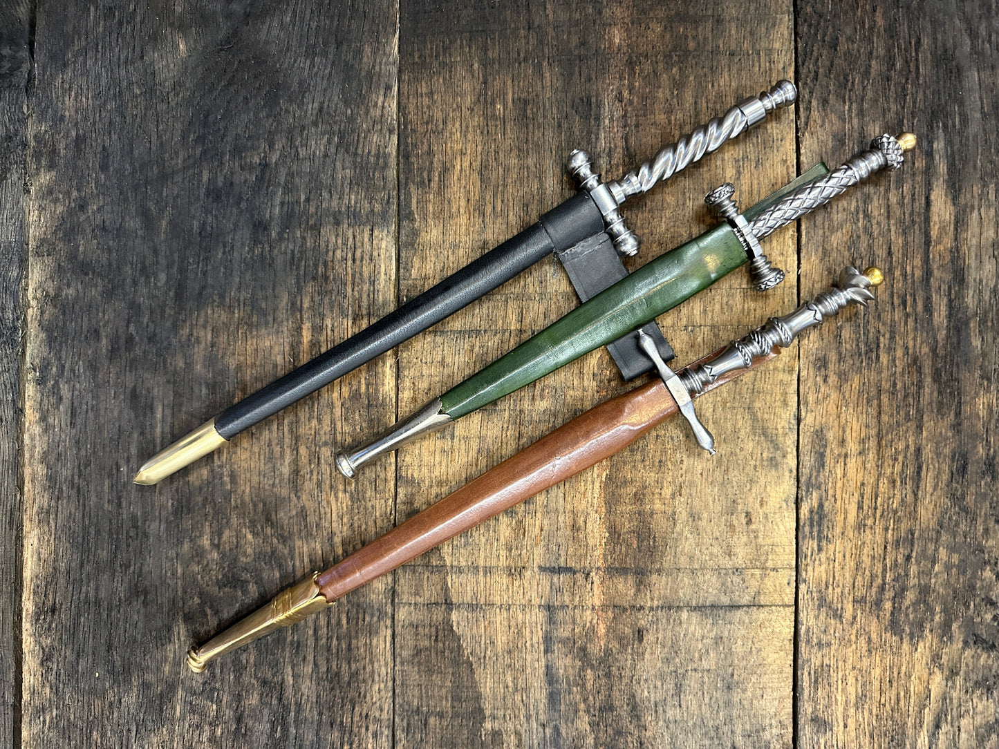 
                  
                    The Stibbert, the Pitt Rivers and the original Tod Cutler Stiletto daggers in a black, green and brown scabbard. 
                  
                