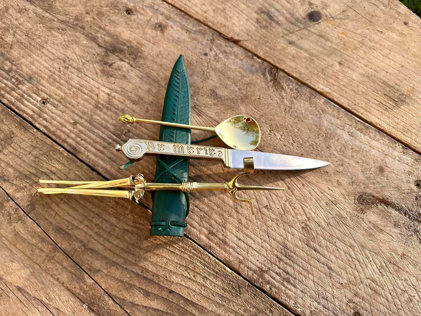 
                  
                    Tod Cutler Christinas bundle of joy - be merie eating knife, brass spoon, brass candlestick
                  
                