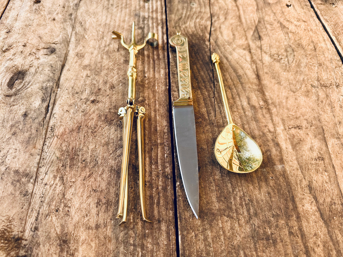 
                  
                    Tod Cutler Christinas bundle of joy - be merie eating knife, brass spoon, brass candlestick
                  
                