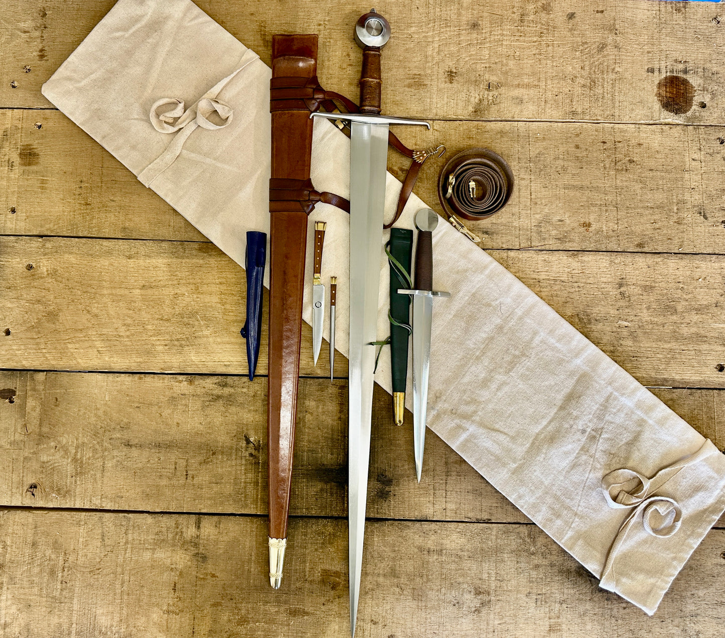 
                  
                    15th Century single handed sword, 12th - 17th century quillon dagger and 15th century two-piece eating set with sword bag (out of scabbards)
                  
                