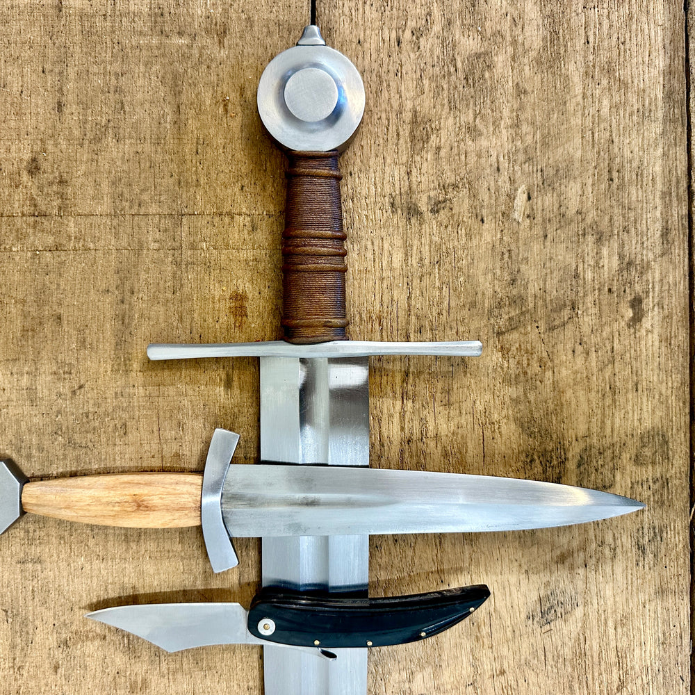 
                  
                    13 - 15th Century Single-handed sword, Late 13th Century Quillon Dagger, 13 - 15th Century Horn folding knife close-up (no scabbards)
                  
                