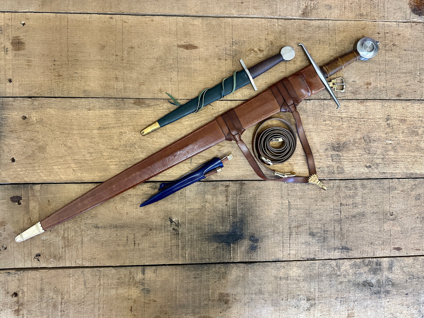 
                  
                    15th Century single handed sword, 12th - 17th century quillon dagger and 15th century two-piece eating set (in scabbards linear)
                  
                