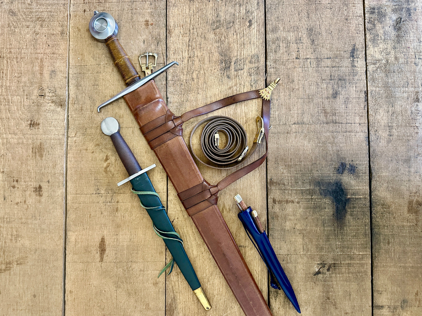 
                  
                    15th Century single handed sword, 12th - 17th century quillon dagger and 15th century two-piece eating set (in scabbards)
                  
                