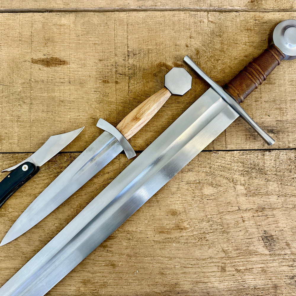 
                  
                    13 - 15th Century Single-handed sword, Late 13th Century Quillon Dagger, 13 - 15th Century Horn folding knife close-up linear (no scabbards)
                  
                