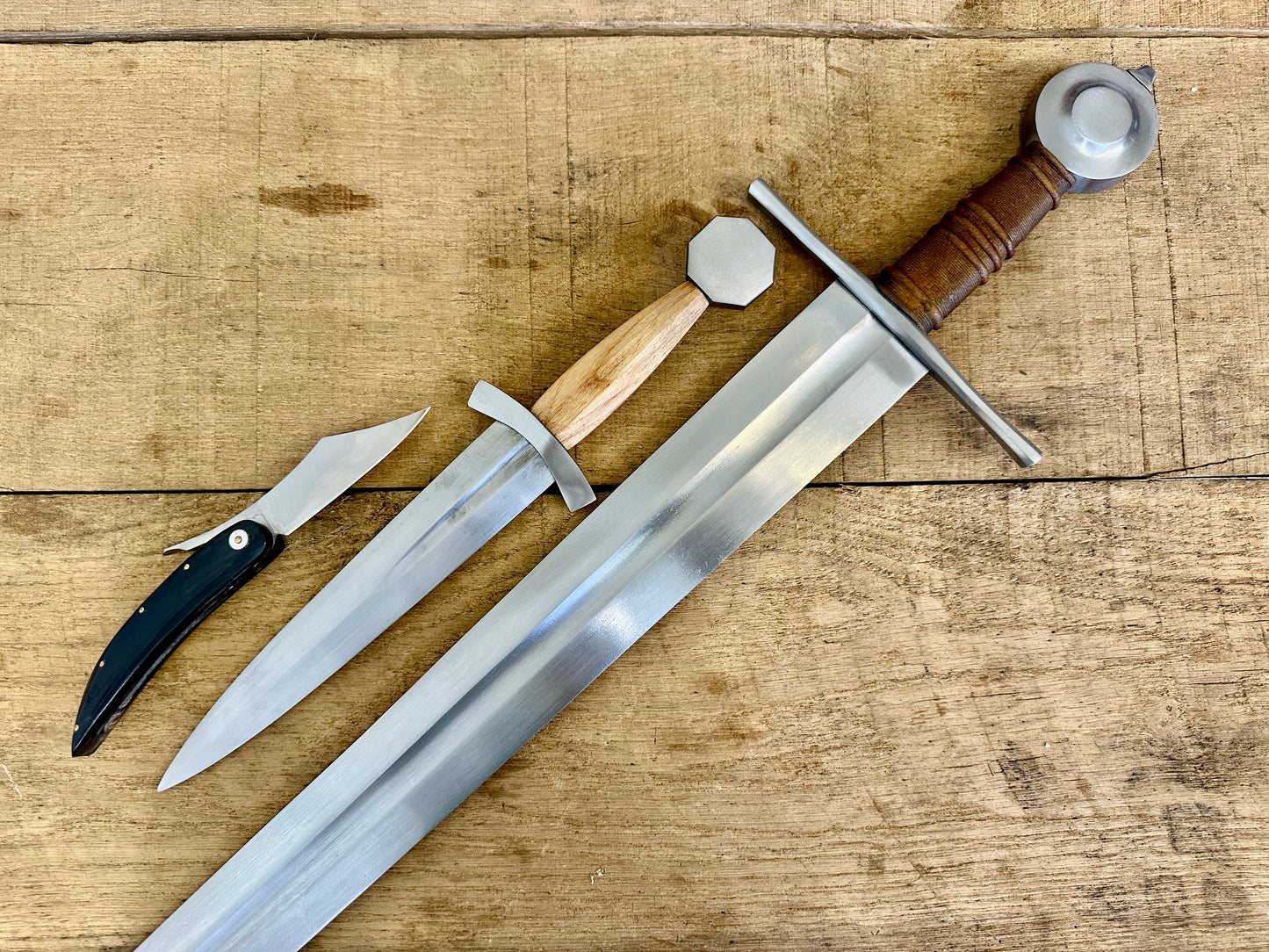 
                  
                    13 - 15th Century Single-handed sword, Late 13th Century Quillon Dagger, 13 - 15th Century Horn folding knife close-up linear (no scabbards)
                  
                