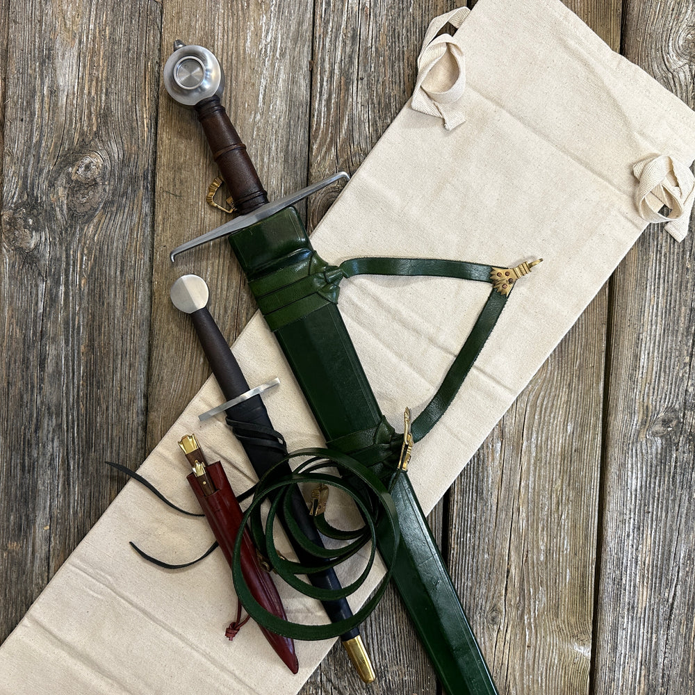 
                  
                    Castillon bundle with a sword and green scabbard, a quillon dagger with black scabbard and an eating set with knife and pricker and a red scabbard. There is also a free cotton sword bag.
                  
                