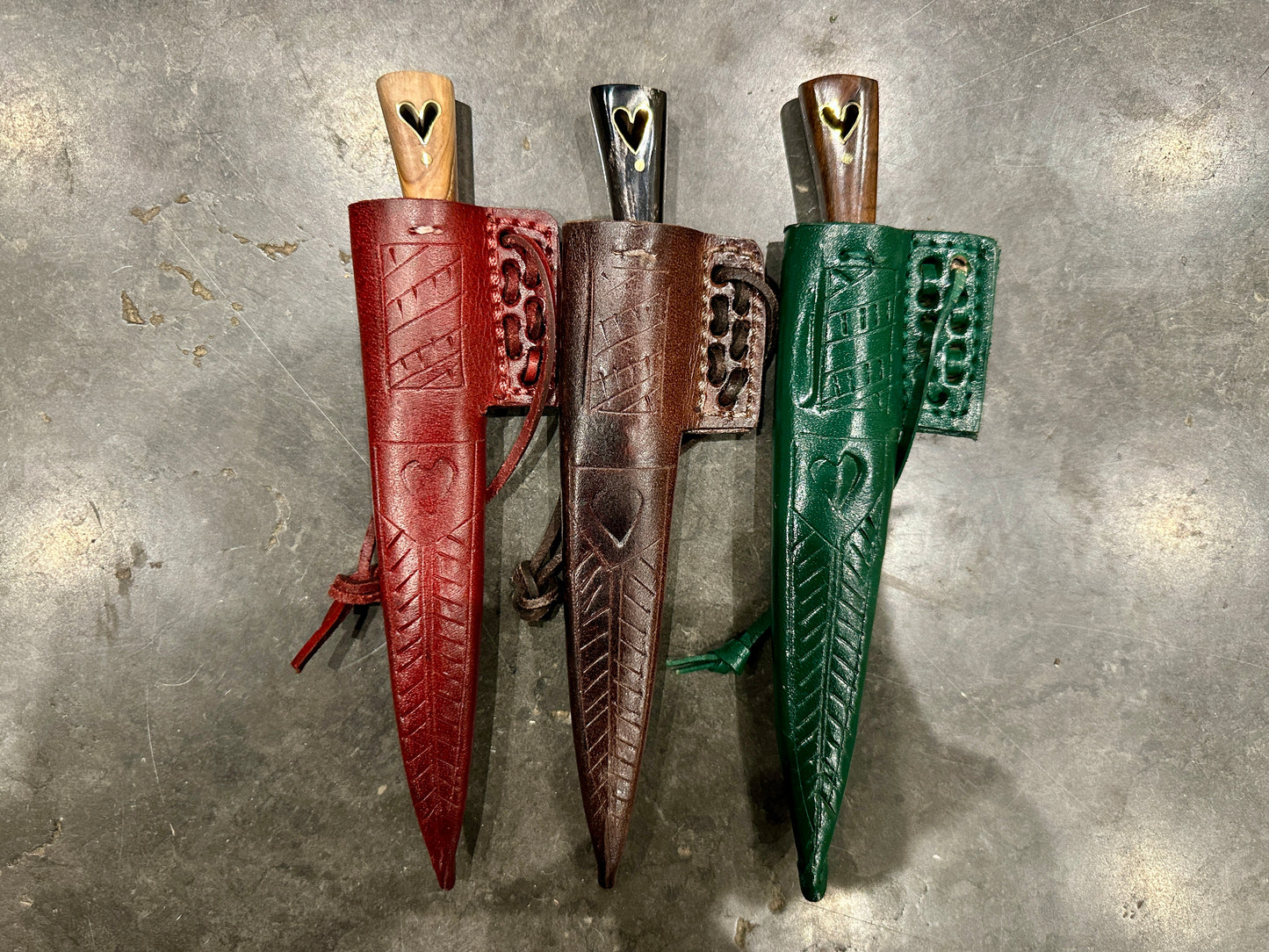 
                  
                    Set of three eating knives in their scabbards

                  
                