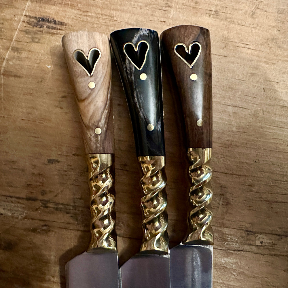 
                  
                    Close up of three eating knives 
                  
                