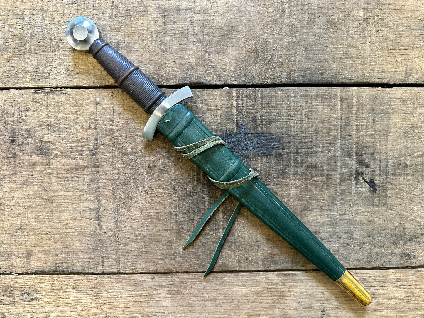 
                  
                    14thC Quillon Dagger. In green scabbard.
                  
                