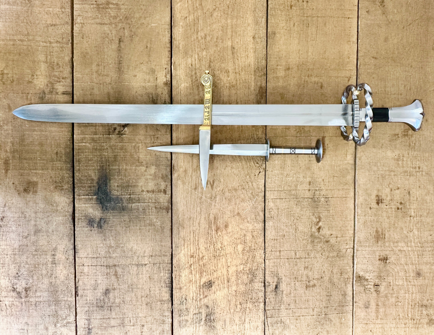 
                  
                    Katzbalger sword 1490 - 1540, 15th Century German Landsknecht steel Rondel, 13 - 16th Century decorated brass-handled eating knife crossed (no scabbards)
                  
                