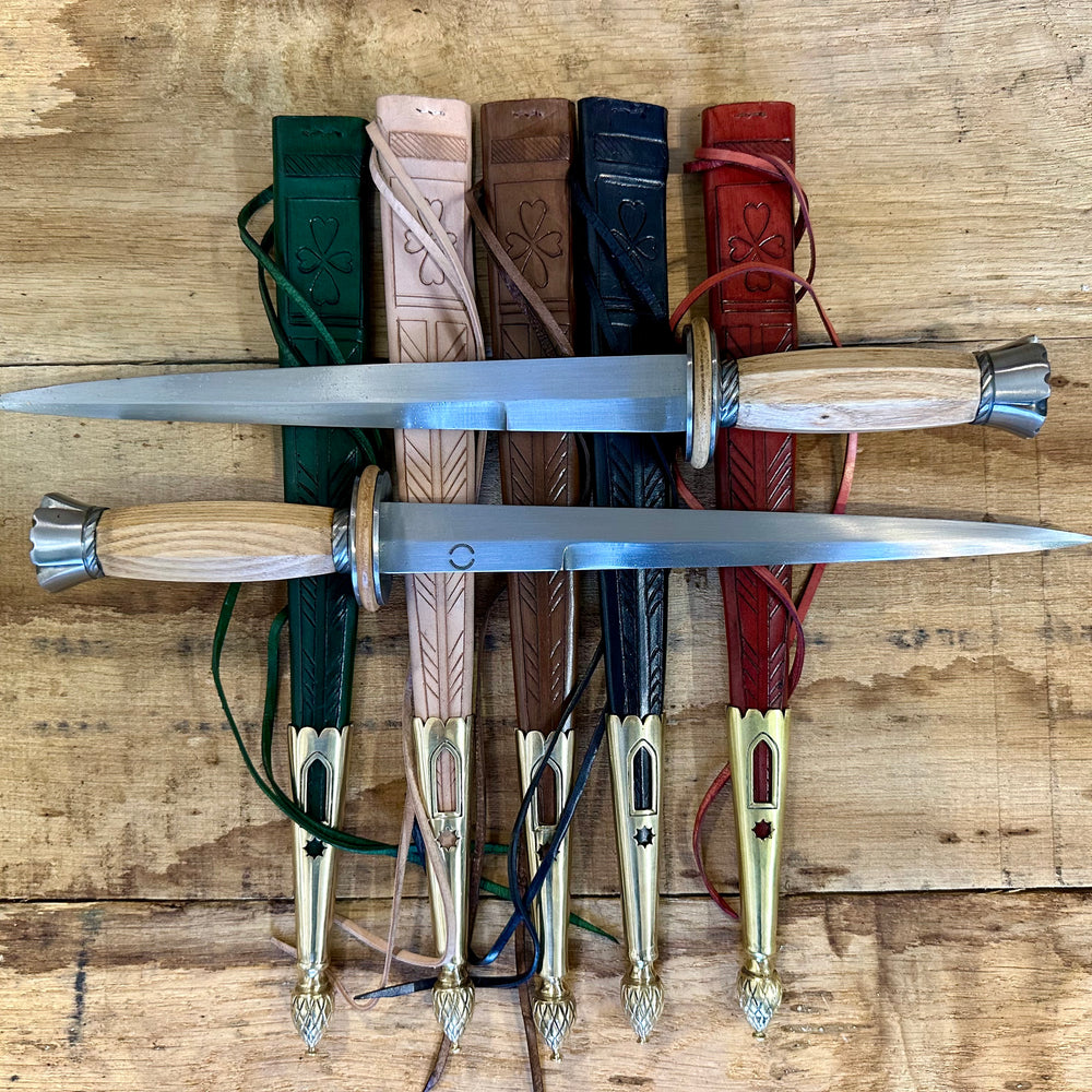 Tod Cutler English Rondel. Two daggers pictured on a range of coloured sheathes. 
