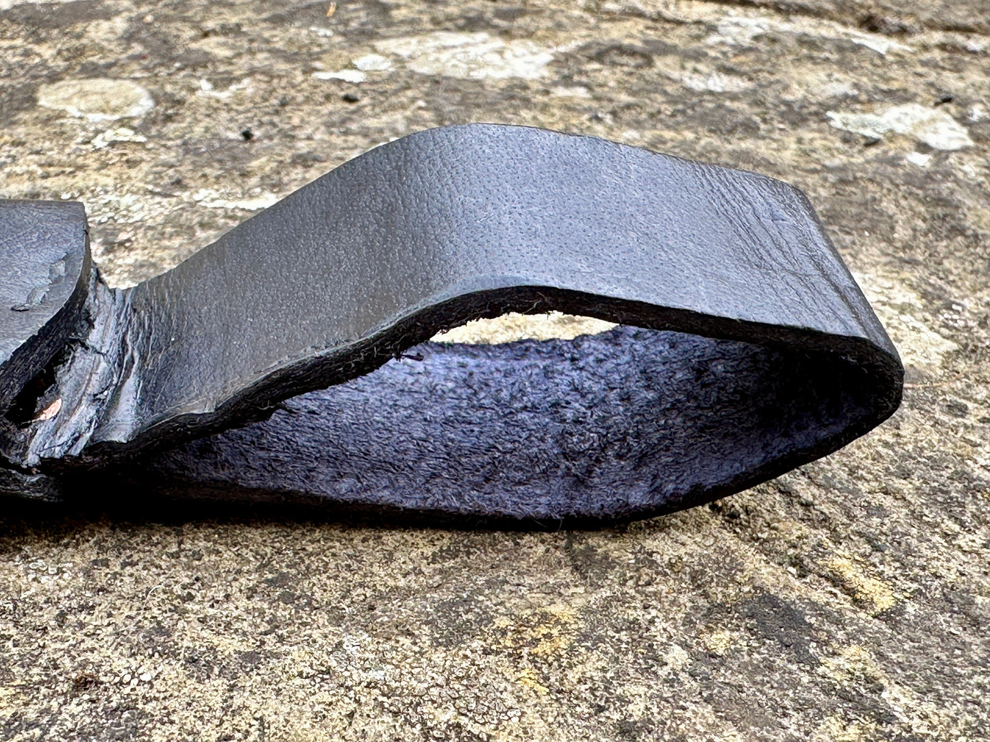 
                  
                    18thC Short brass and black wood dirk. Close up of belt loop. 
                  
                