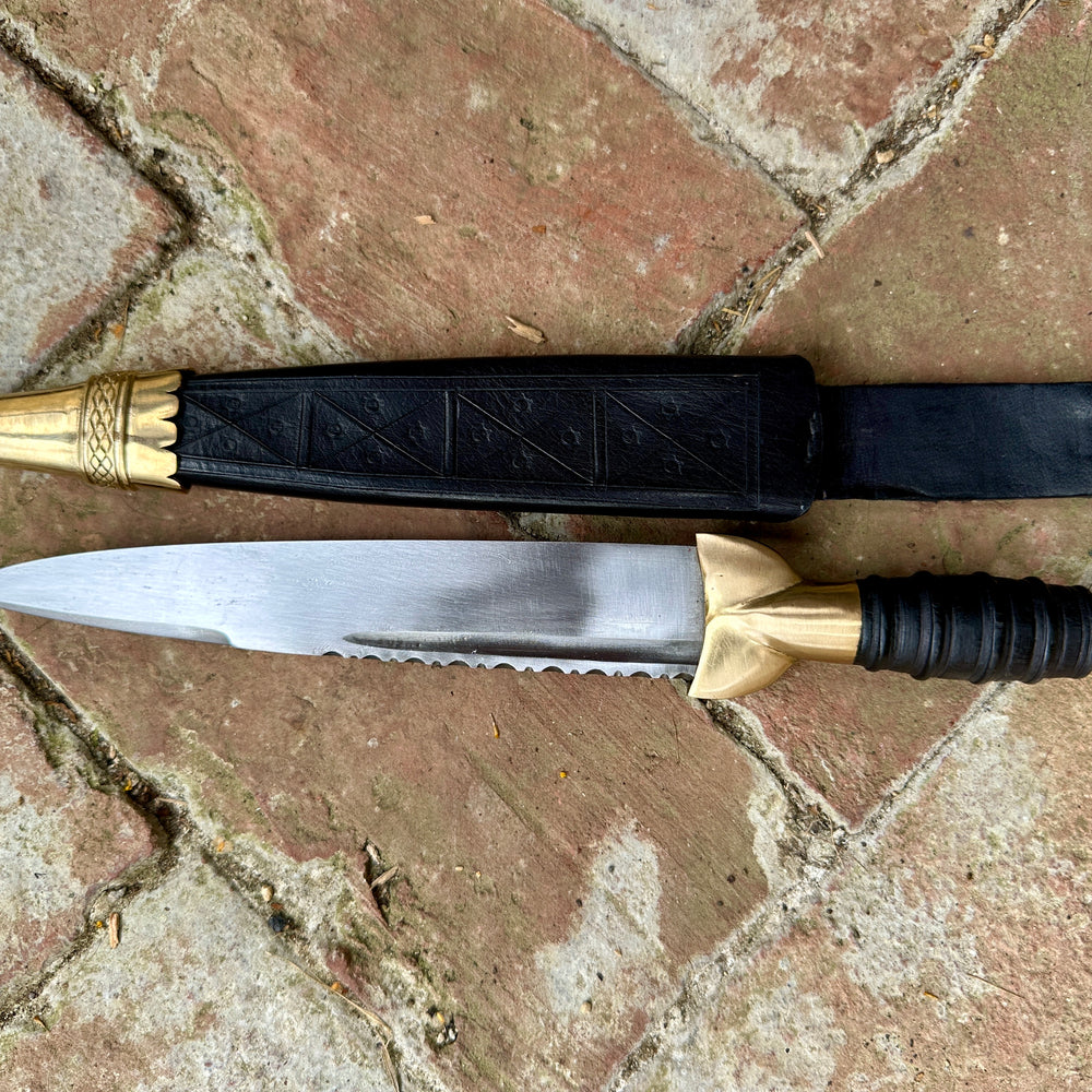 
                  
                    18thC Short brass and black wood dirk. Black.
                  
                