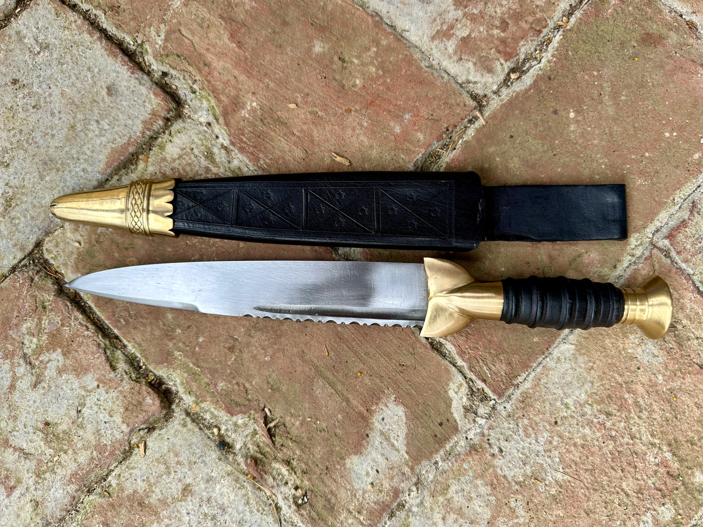 
                  
                    18thC Short brass and black wood dirk. Black.
                  
                