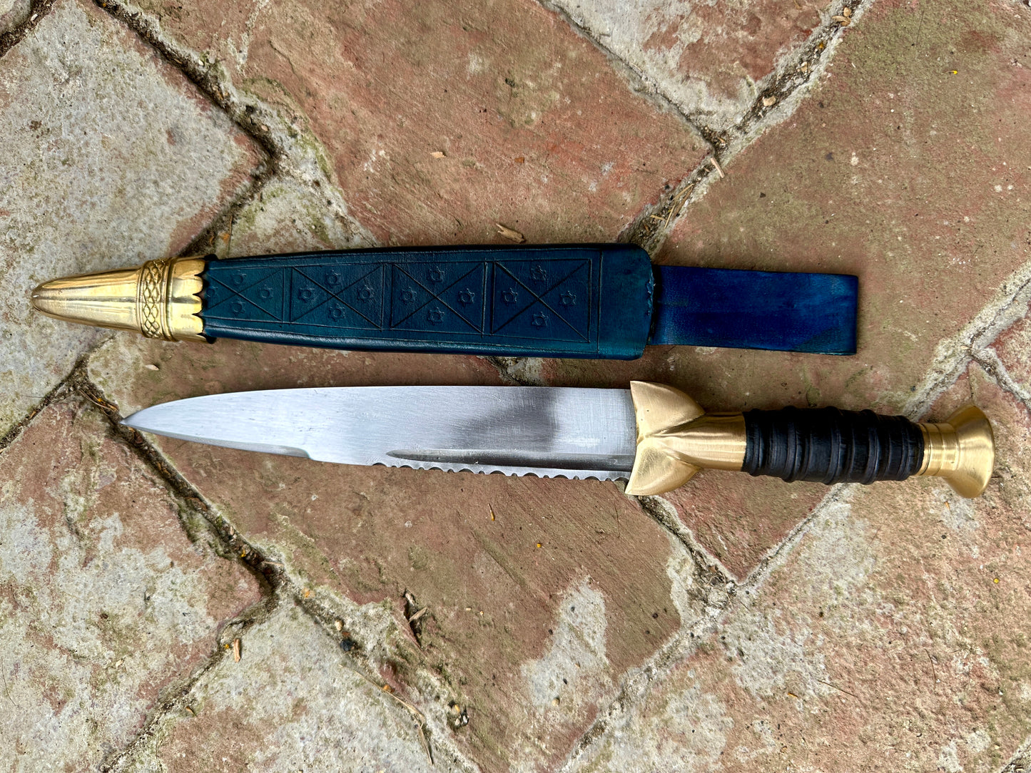 
                  
                    18thC Short brass and black wood dirk. Blue.
                  
                