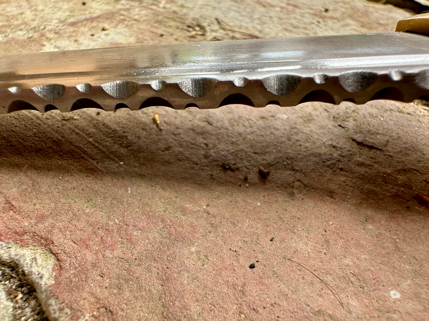 
                  
                    18thC short brass and black wood dirk. Close up of file work.
                  
                