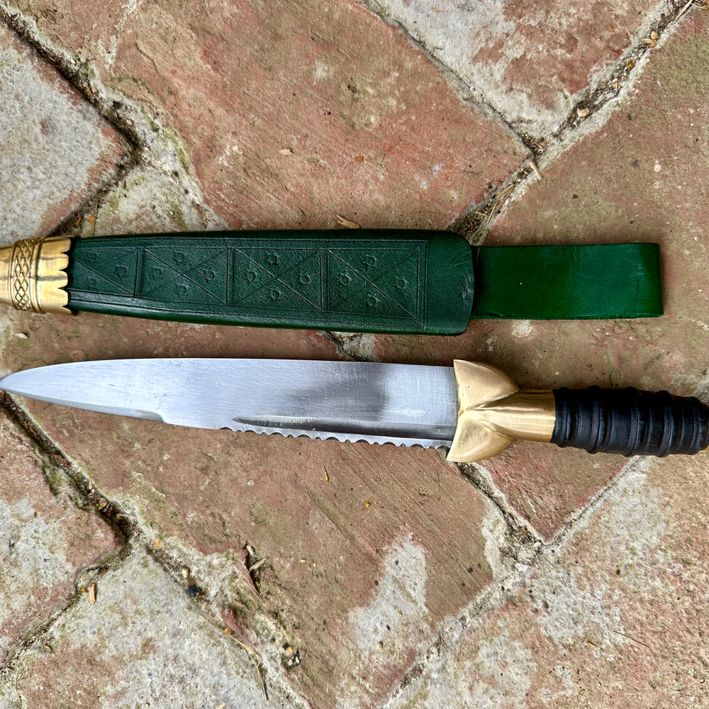 
                  
                    18thC Short brass and black wood dirk. Green.
                  
                