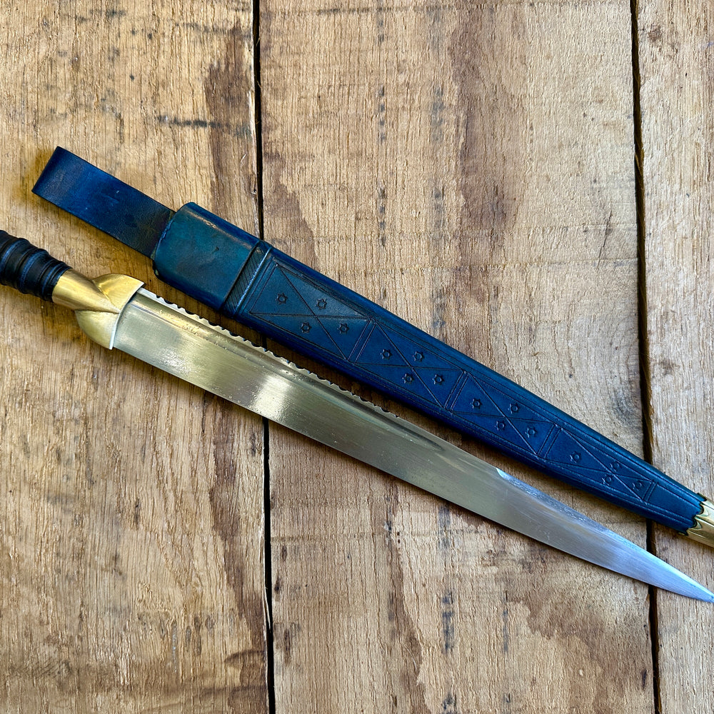 
                  
                    18thC long brass and wood dirk. With blue scabbard. 
                  
                