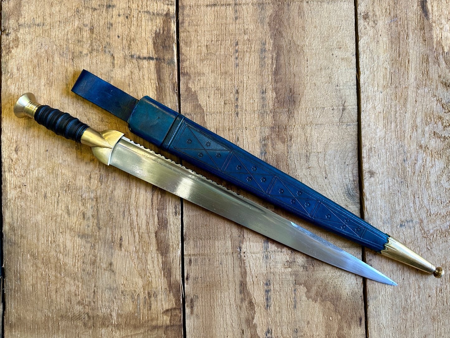 
                  
                    18thC long brass and wood dirk. With blue scabbard. 
                  
                