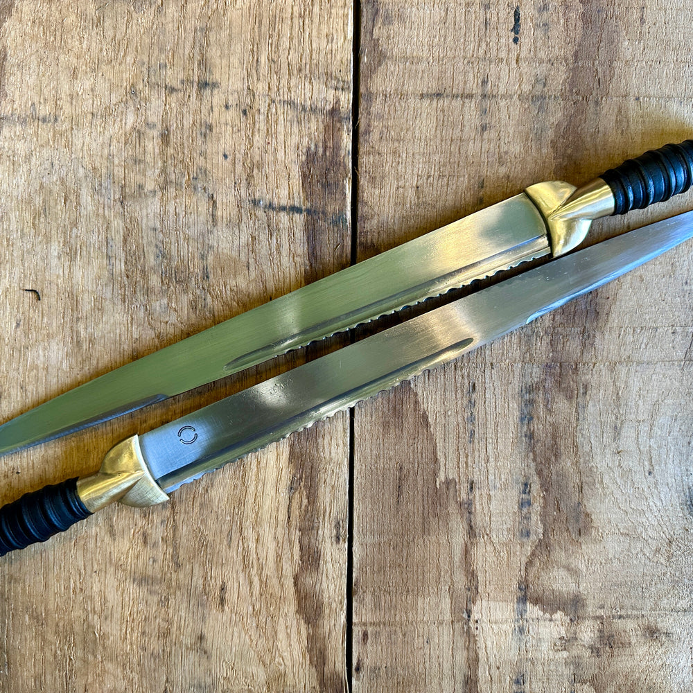 
                  
                    18thC long brass and wood dirk. Two knives.
                  
                