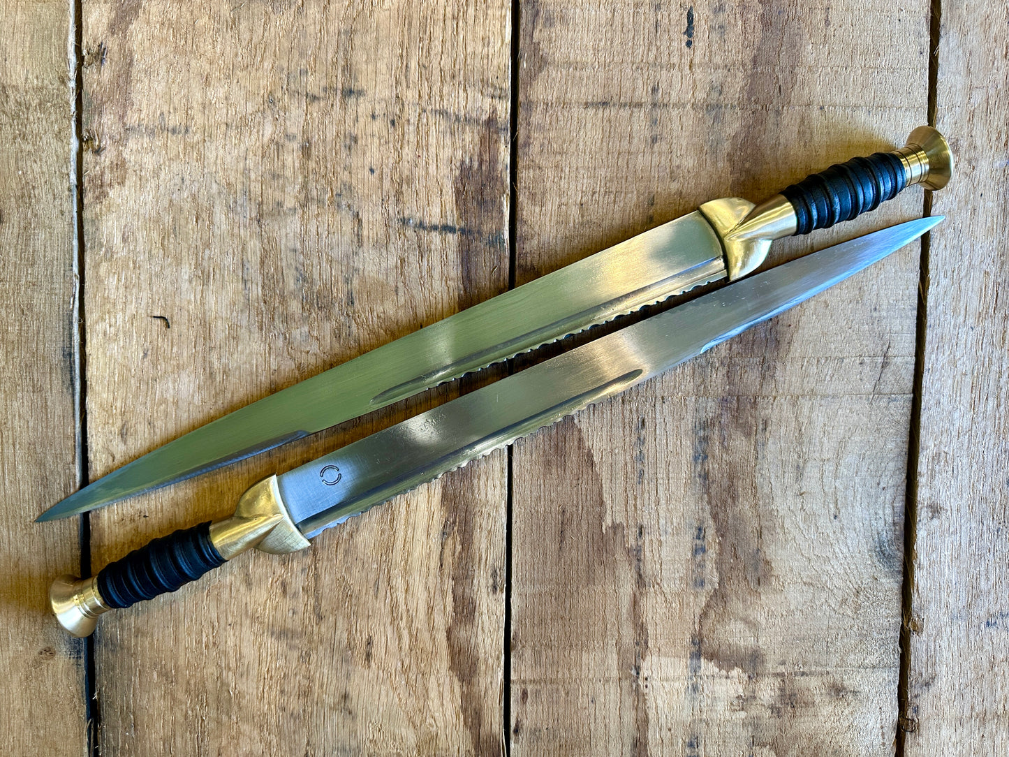 
                  
                    18thC long brass and wood dirk. Two knives.
                  
                