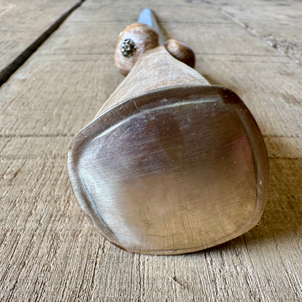 
                  
                    Simple Rothenburg Bollock Dagger. Close up of pommel cap in brass.
                  
                