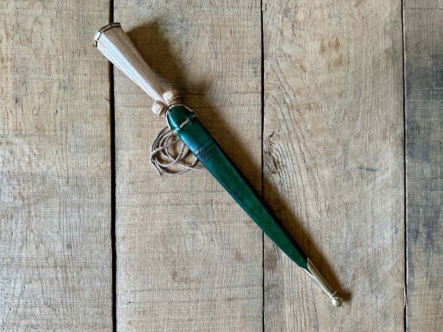 
                  
                    Simple Rothenburg Bollock Dagger in a green scabbard. 
                  
                