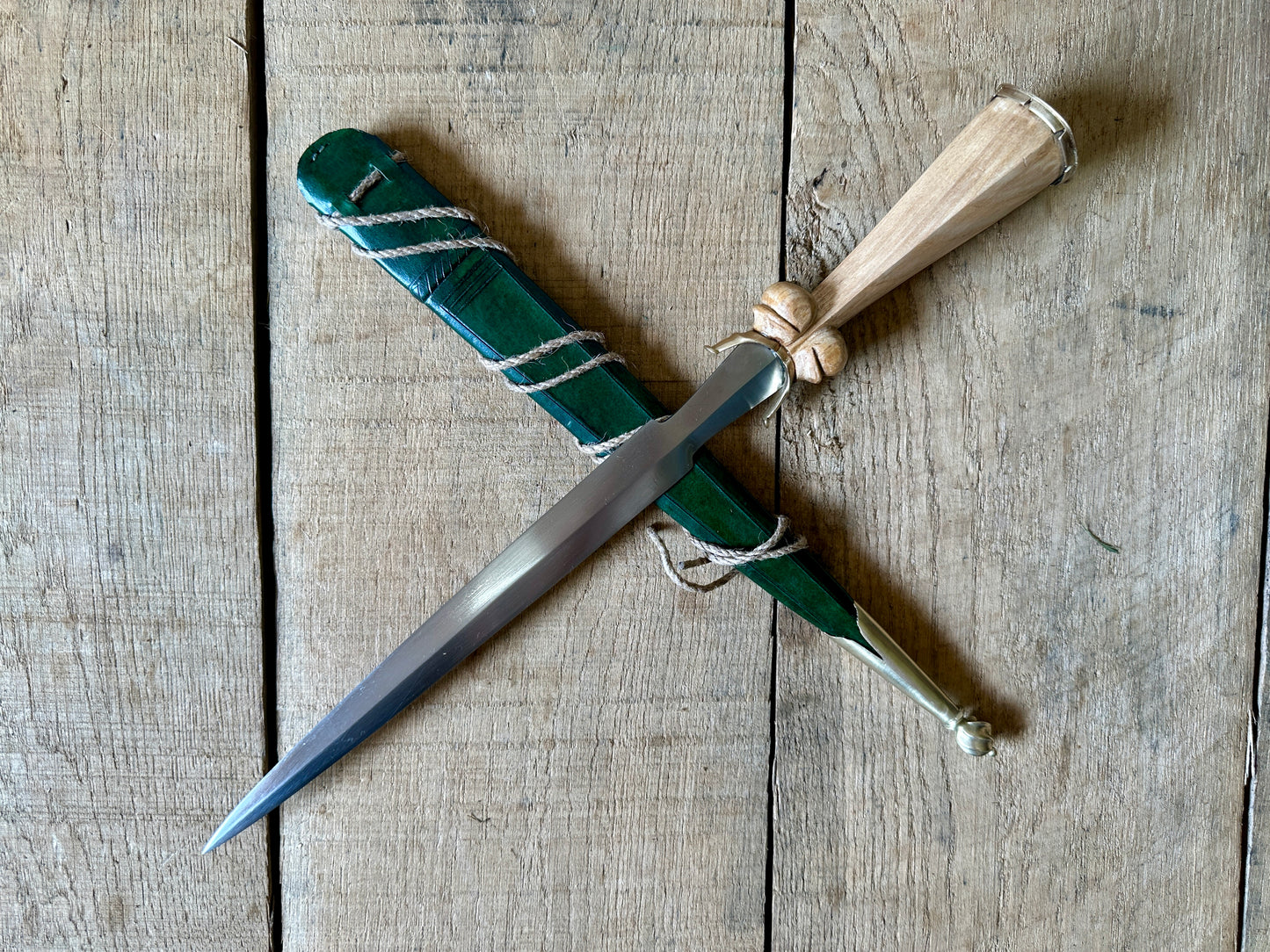 
                  
                    Simple Rothenburg Bollock Dagger with a green scabbard
                  
                