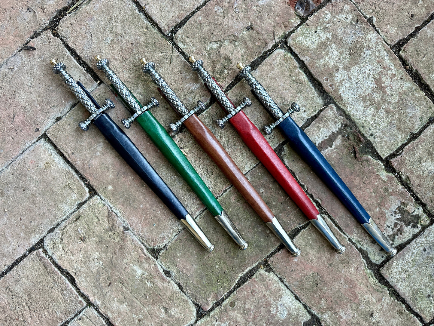 
                  
                    Stibbert Daggers in black, green, brown, red and blue scabbards
                  
                