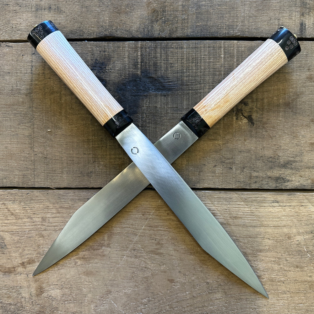 
                  
                    Decorated Anglo Saxon/Viking knives, crossed. 
                  
                