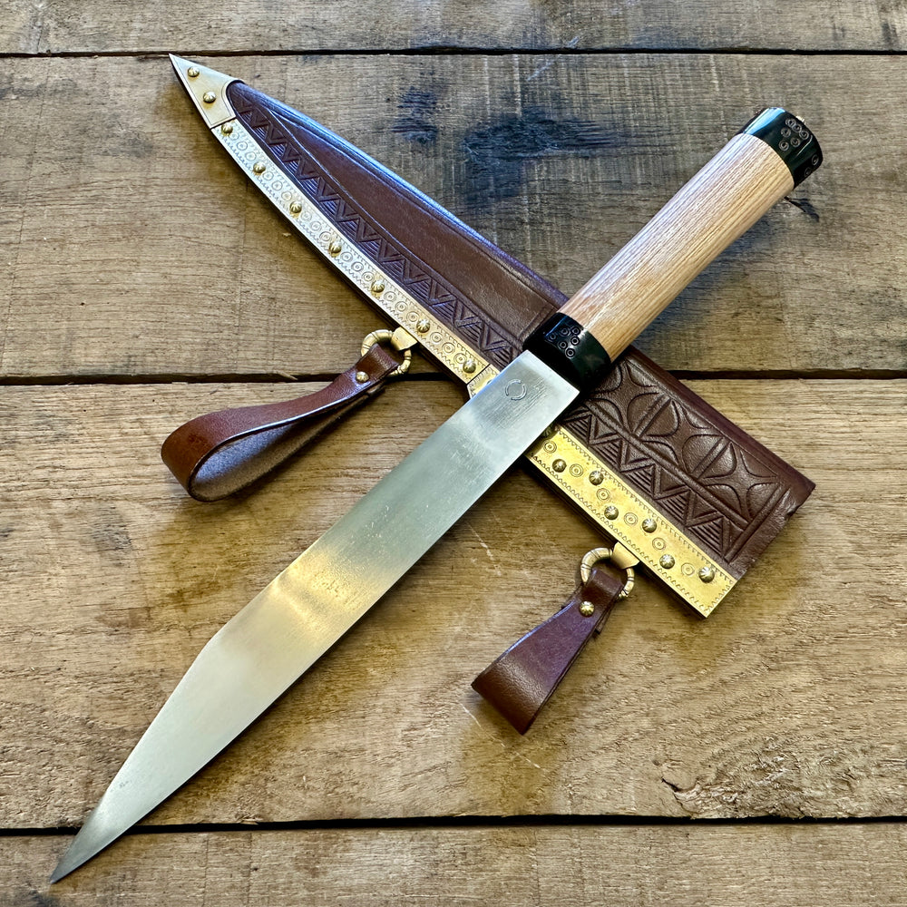 
                  
                    Decorated Anglo Saxon/Viking knife with a brown scabbard 
                  
                