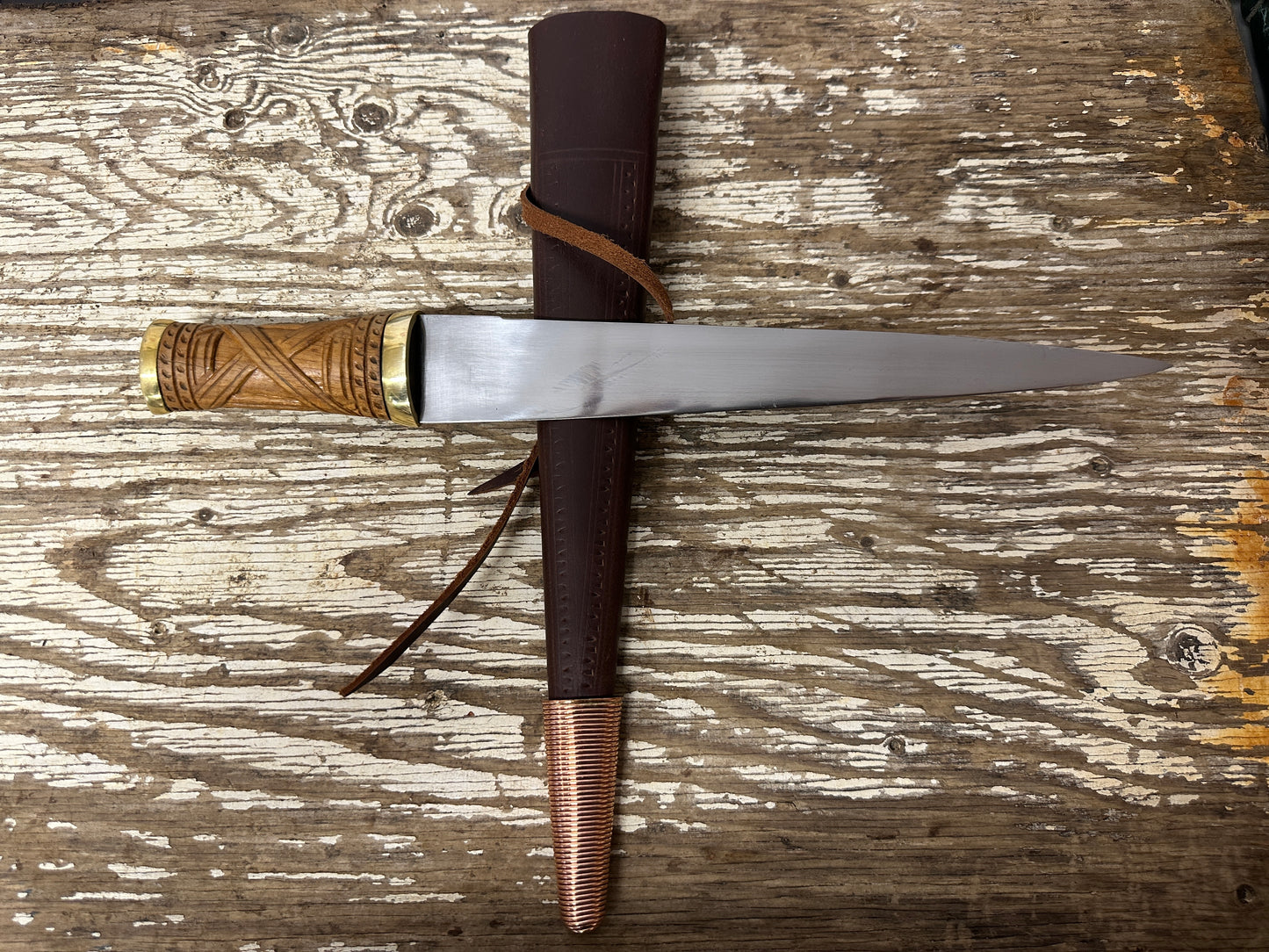 
                  
                    short irish skean with brown scabbard
                  
                